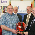 Aidan Boyle presented Trevor Miller with a memento of his visit, also in the picture is Amanda McFadden, David Babington CEO AMH and Mickie Harkin Service Manager AMH New Horizons Foyle