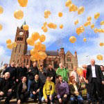 Clients and Staff from AMH New Horizons Foyle celebrate in Guild Hall Square