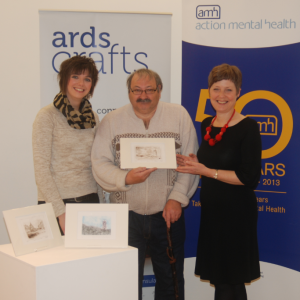 Clients and staff of AMH's New Horizons Service in Newtownards hand over 36 original prints they created to Heather Parker, Craft Development Manager with Ards Borough Council. Ards Crafts will sell the prints at £25 each in the run up to Christmas.