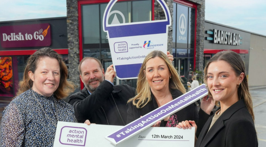 Image shows two AMH employees and two Henderson Group employees standing in front of of a SPAR store. They are holding a large cheque.