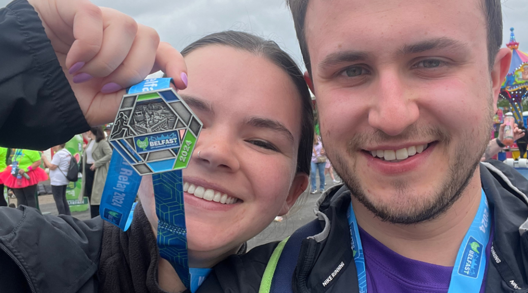 Curtis and his wife at the Belfast marathon finish line with their medals