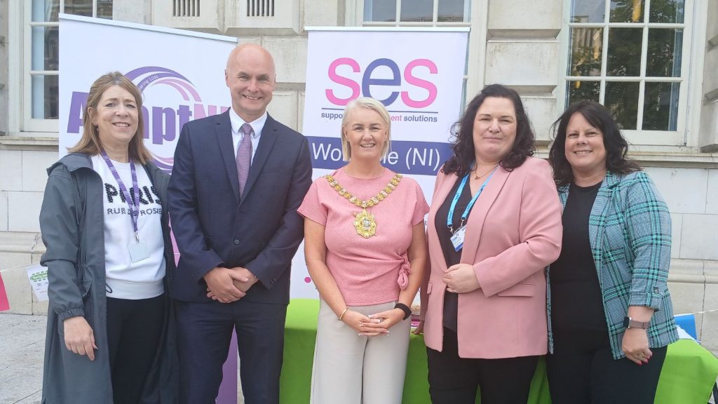 The Lord Mayor of Belfast standing with staff from SES outside Belfast City Hall. 