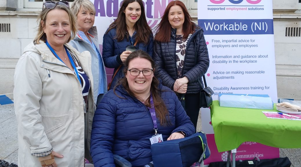 A group of staff and participants from SES Workable (NI) gathered outside Belfast City Hall.