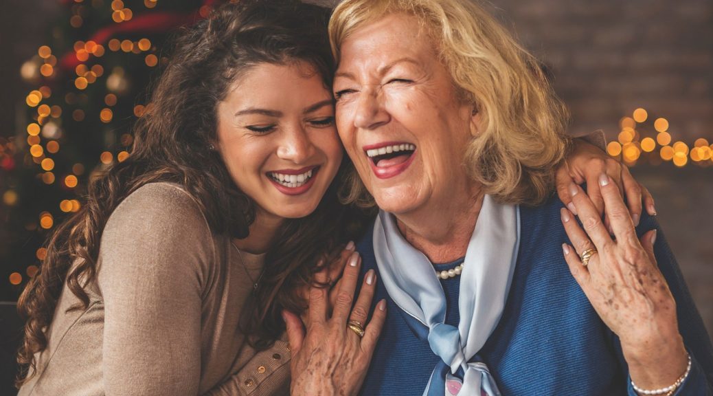 A young woman and her grandmother enjoying a Christmas dinner.