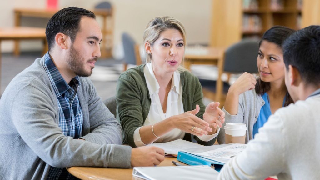A group of colleagues chatting in an informal meeting. 