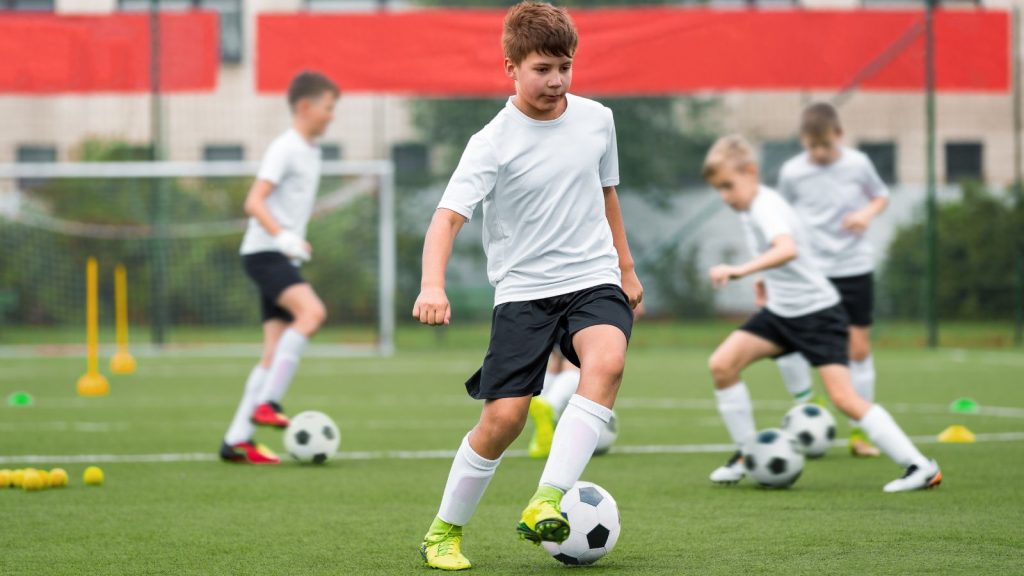 A boy playing football.