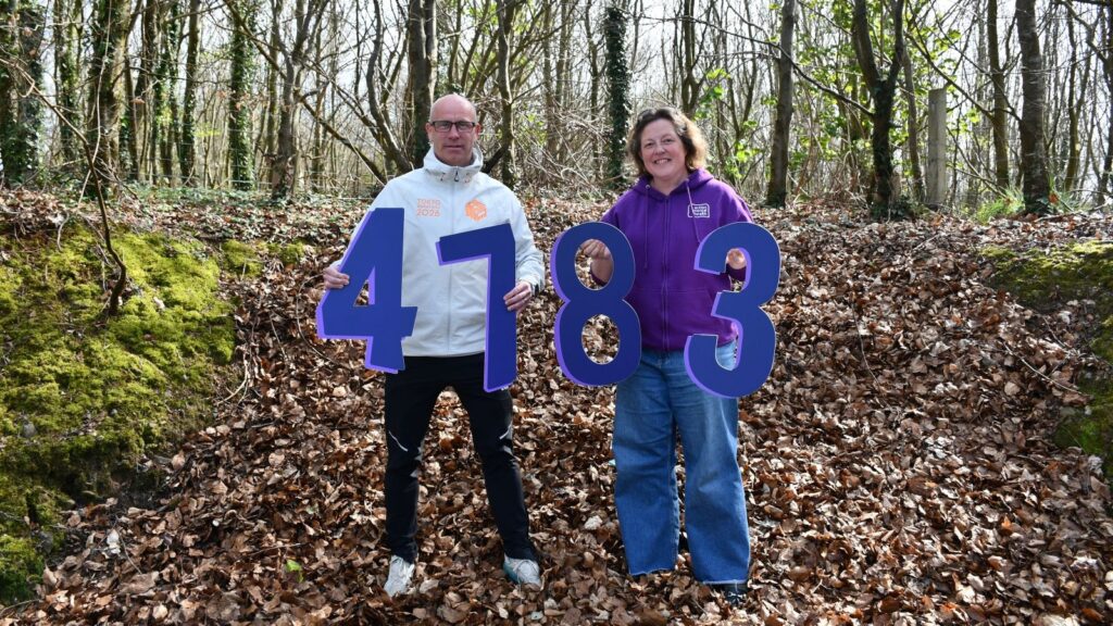 Fundraiser, Stuart McIver, stand with Jane from Action Mental Health, showing his fundraising total of £4783.